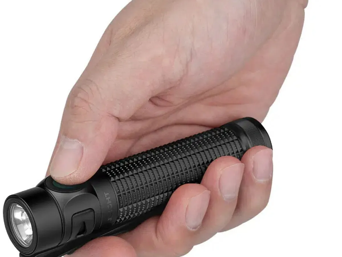 Olight Baton 4 Pro Handheld EDC Scale Hand holding the compact black Olight Baton 4 Pro everyday carry flashlight