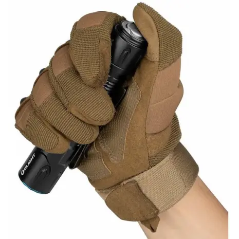 Olight Warrior 3S 2300lm Flashlight - brown-gloved hand holding black flashlight at tail switch Olight Warrior 3S 2300lm Flashlight - brown-gloved hand holding black flashlight at tail switch