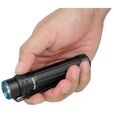 Olight Warrior Mini 3 1750 Lumen Flashlight - hand holding black flashlight with blue lens rim Olight Warrior Mini 3 1750 Lumen Flashlight - hand holding black flashlight with blue lens rim
