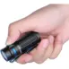 Olight Baton 3 Flashlight - Black - hand holding black compact flashlight with blue trim
